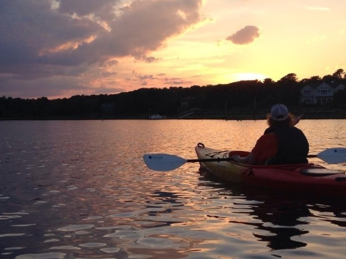 A man in a kayak on a Cape Cod Sunset Kayak Tour with RideAway Adventures