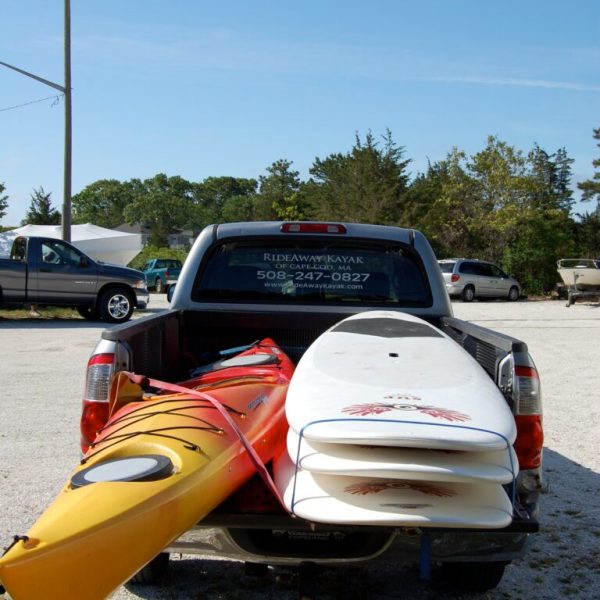A RideAway Adventures truck loaded up with kayaks and paddleboards for delivery on Cape Cod