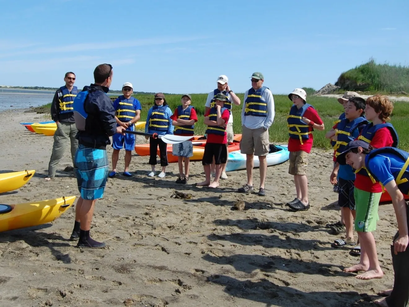 Kayaking for Beginners group getting lessons on the beach from RideAway Adventures