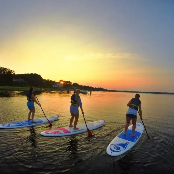 Paddle-board-Cape-Cod-Girls-600×600 Three woman on a RideAway paddle board adventure at sunset through Cape Cod waters